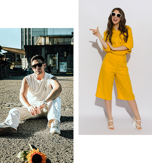 A man in a white outfit sits on the ground outdoors, while a woman in a yellow outfit stands indoors, pointing to the side. Both wear sunglasses.