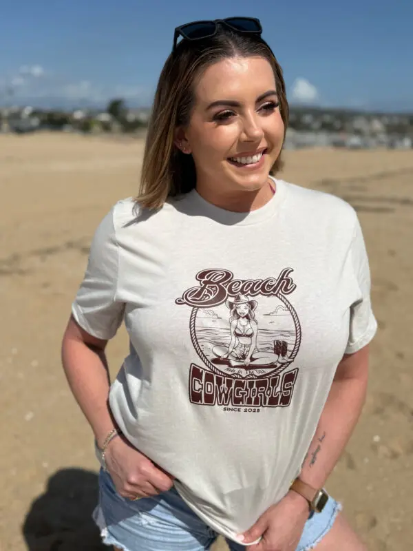 A woman standing on top of a sandy beach.